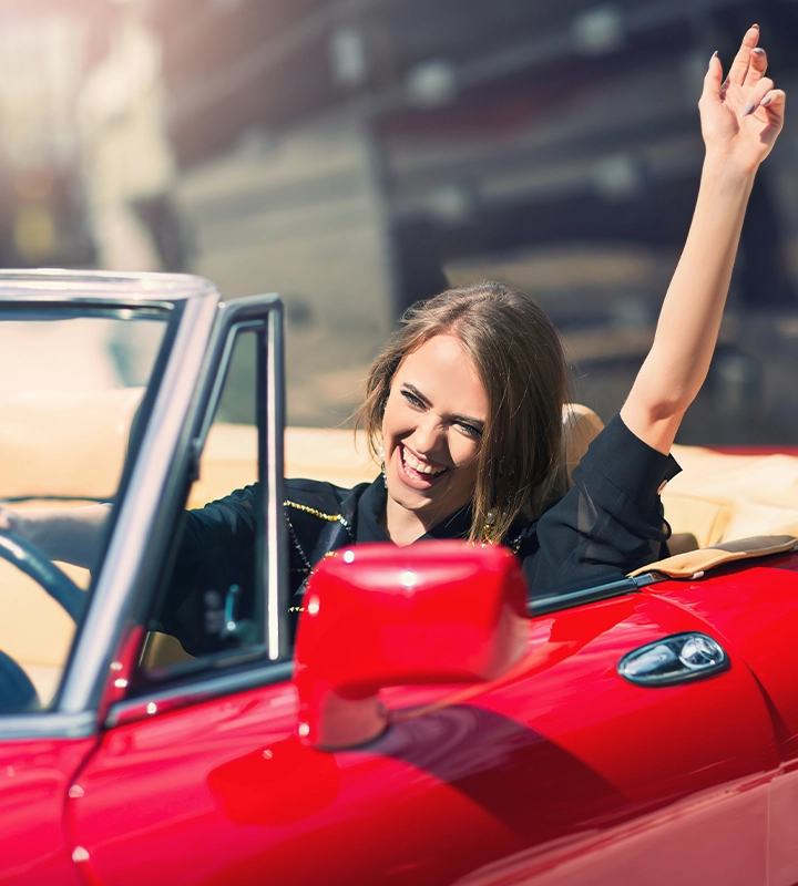 A woman model sitting in luxury retro cabriolet car
