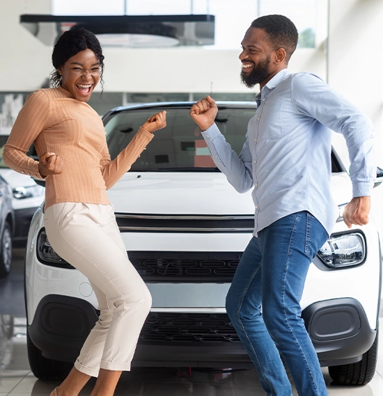 Excited African American Spouses Dancing In Dealership After Buying New Car