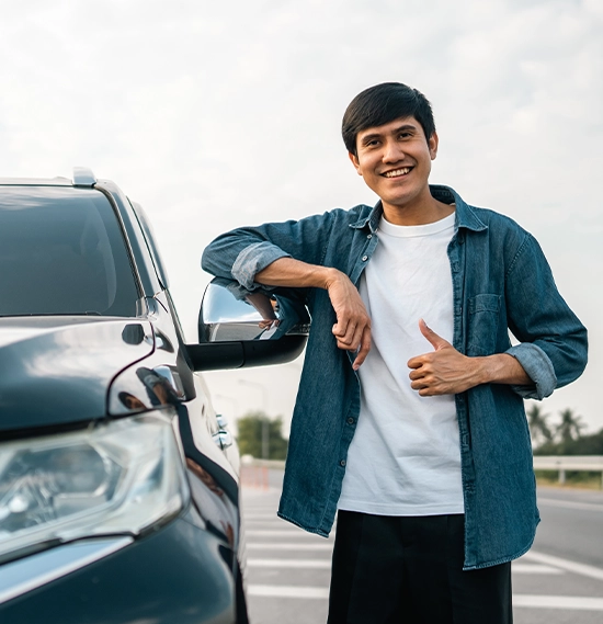 Young handsome asian man getting the new car